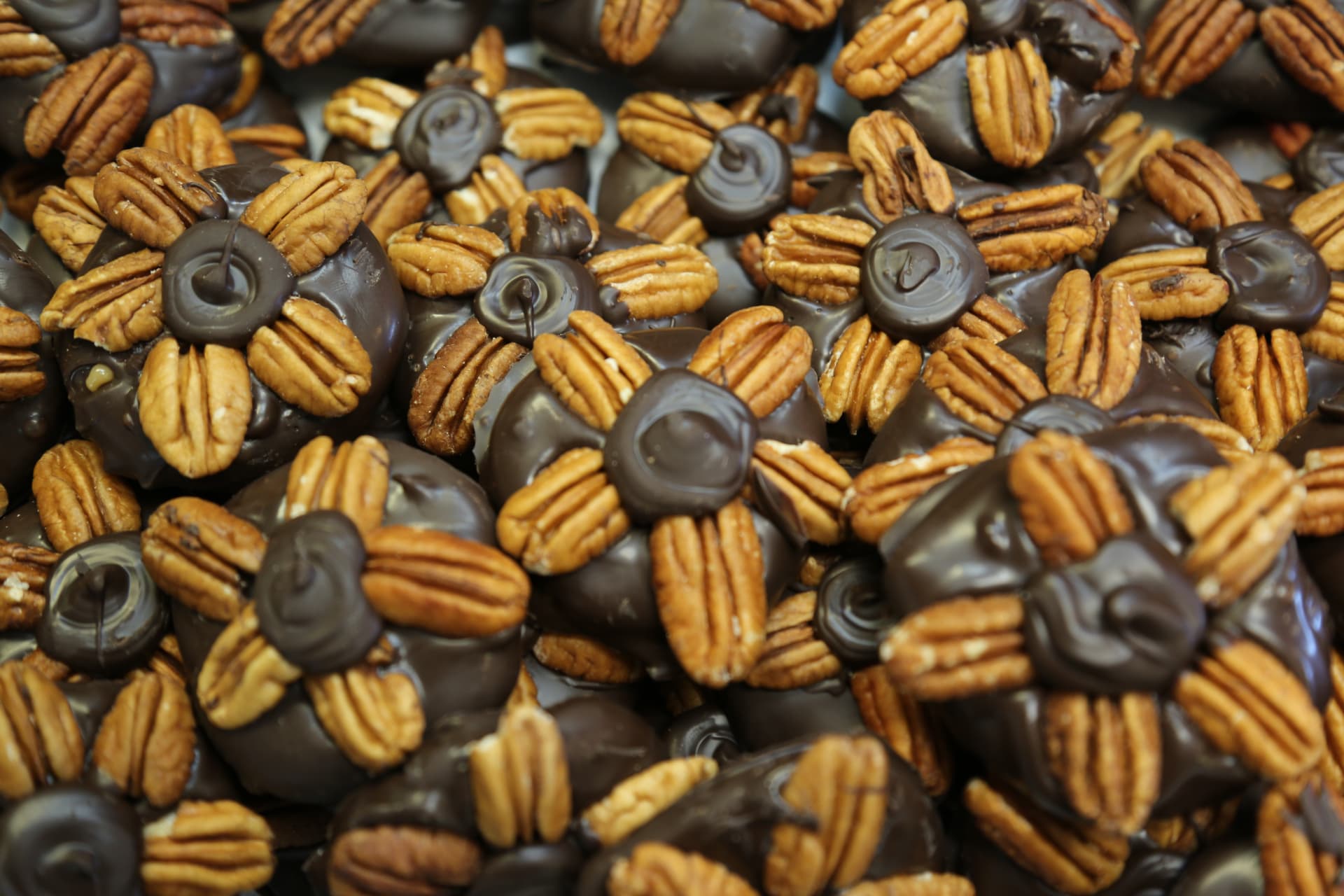 Chocolate-covered pecan turtle candies with caramel