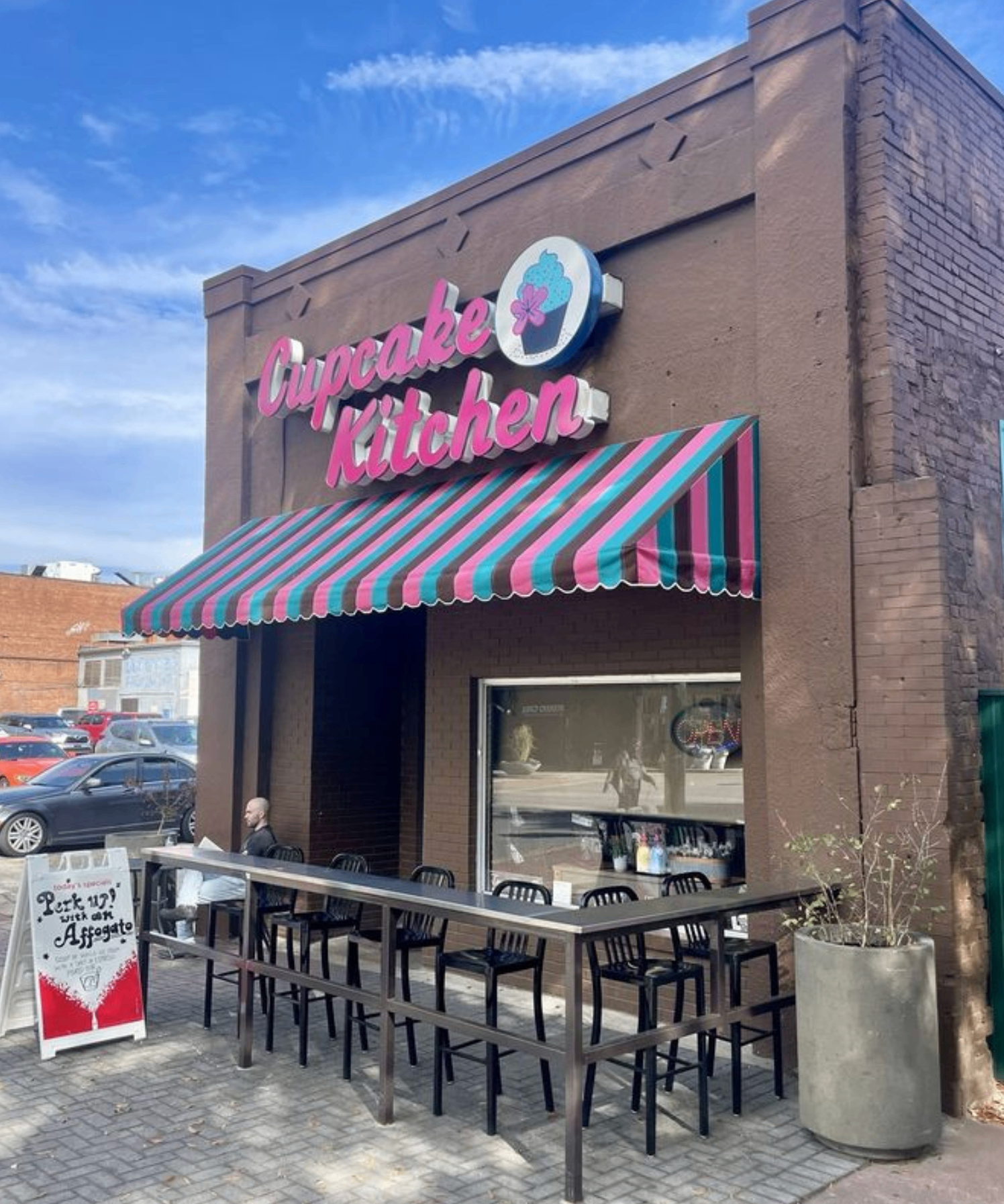 Cupcake Kitchen storefront on Broad Street with pink neon sign and turquoise, pink, and brown striped awning