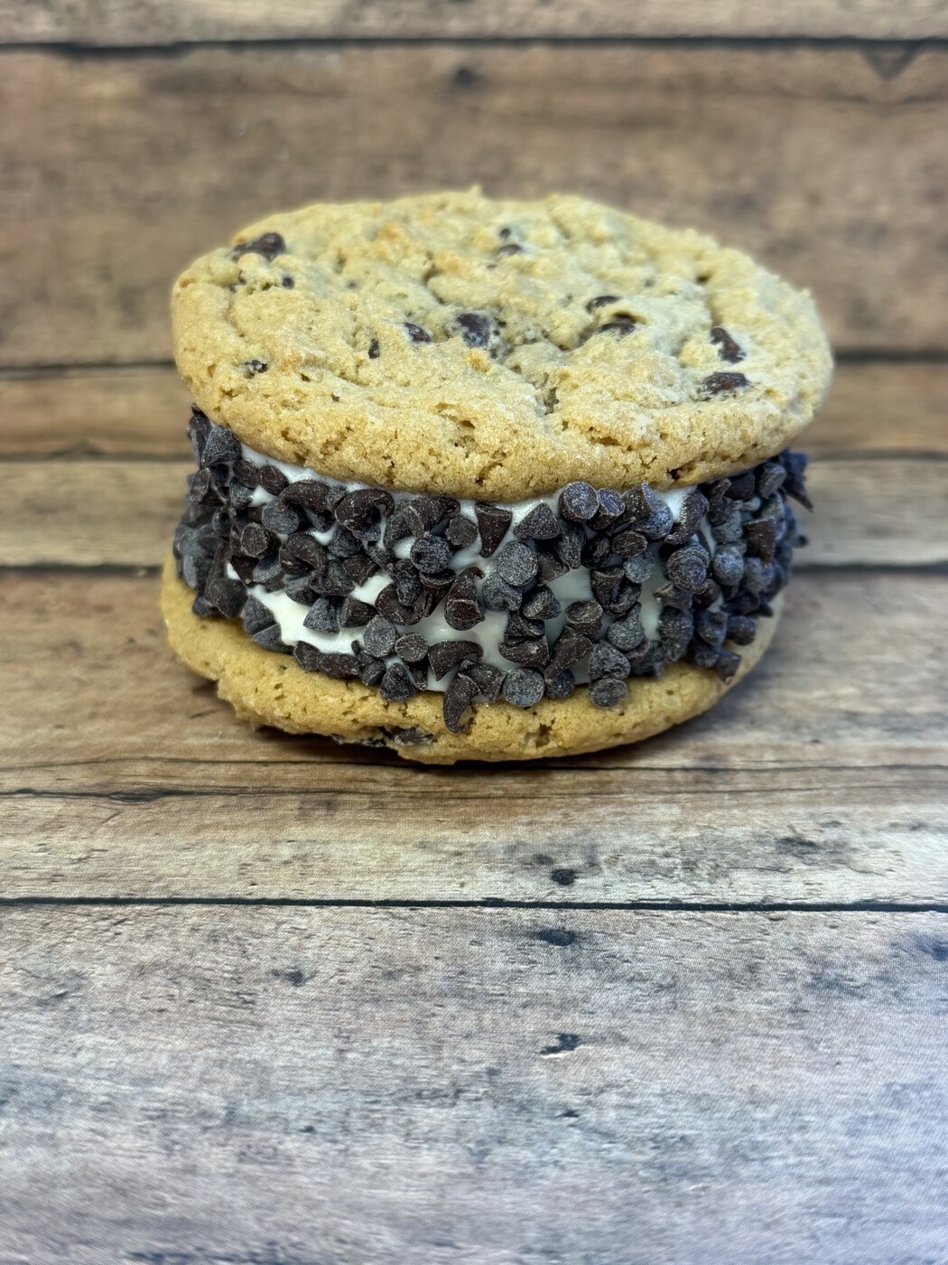 Chocolate chip cookie ice cream sandwich with vanilla ice cream rolled in mini chocolate chips