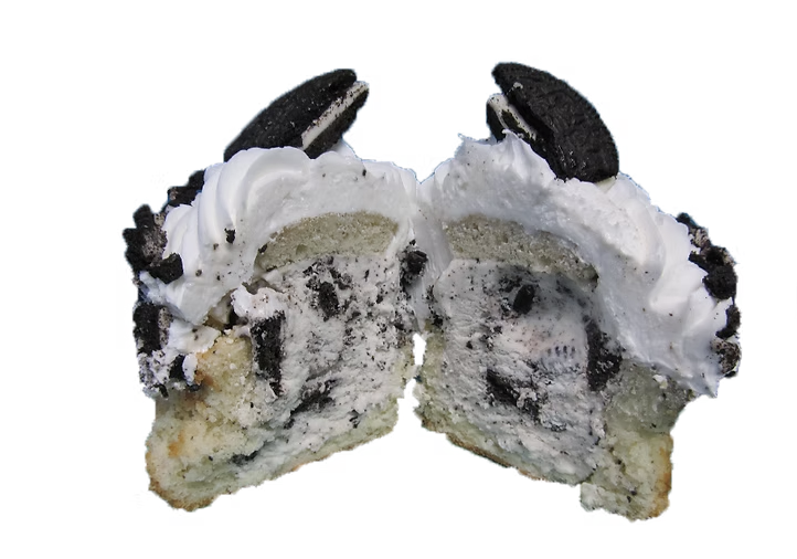 Cookies and cream ice cream cupcake cut in half showing Oreo-studded ice cream and whipped frosting with Oreo halves