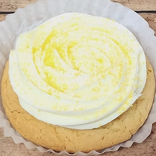 Sugar cookie topped with swirled lemon icing and zest